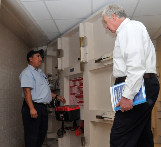 FEMA Dep. Administrator Rich Serino is shown how a Presray FB77 Flood Door, or 